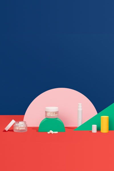 Various Wisp vaginal health medications sit on colorful geometric background
