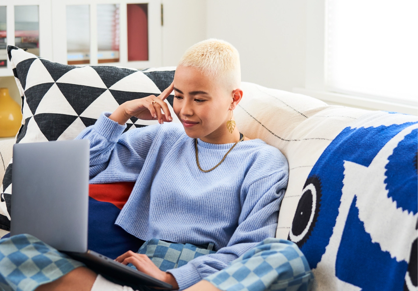 login page image banner of person sitting on couch with laptop