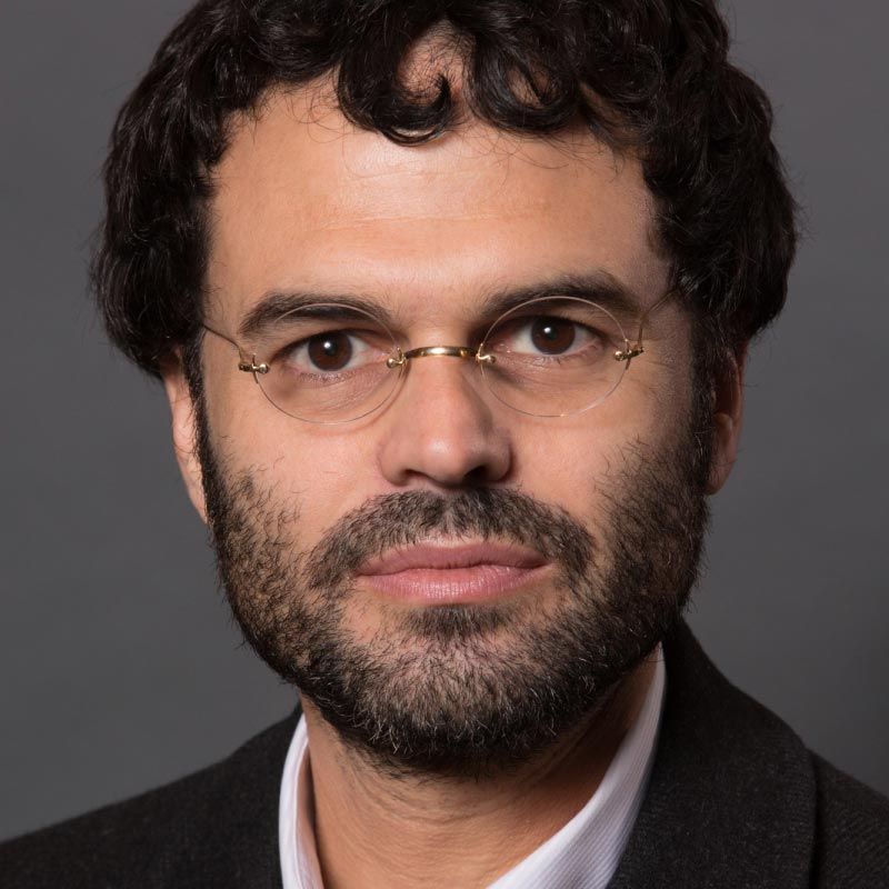Antonio Urbina, MD wearing a black suit jacket and white button down shirt