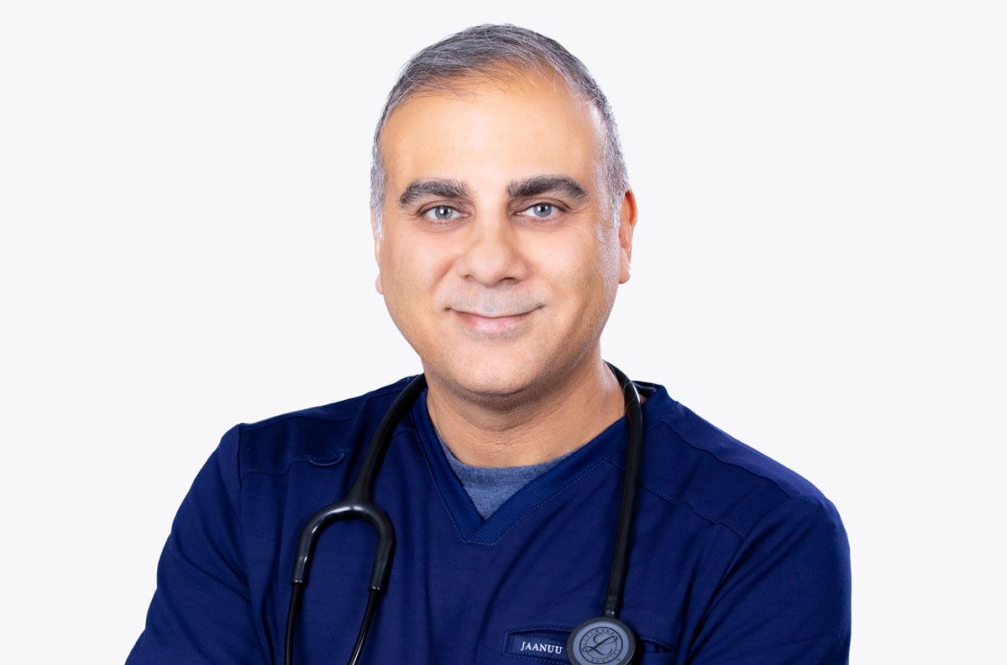 dr suneer chander wearing scrubs with a stethoscope around his neck