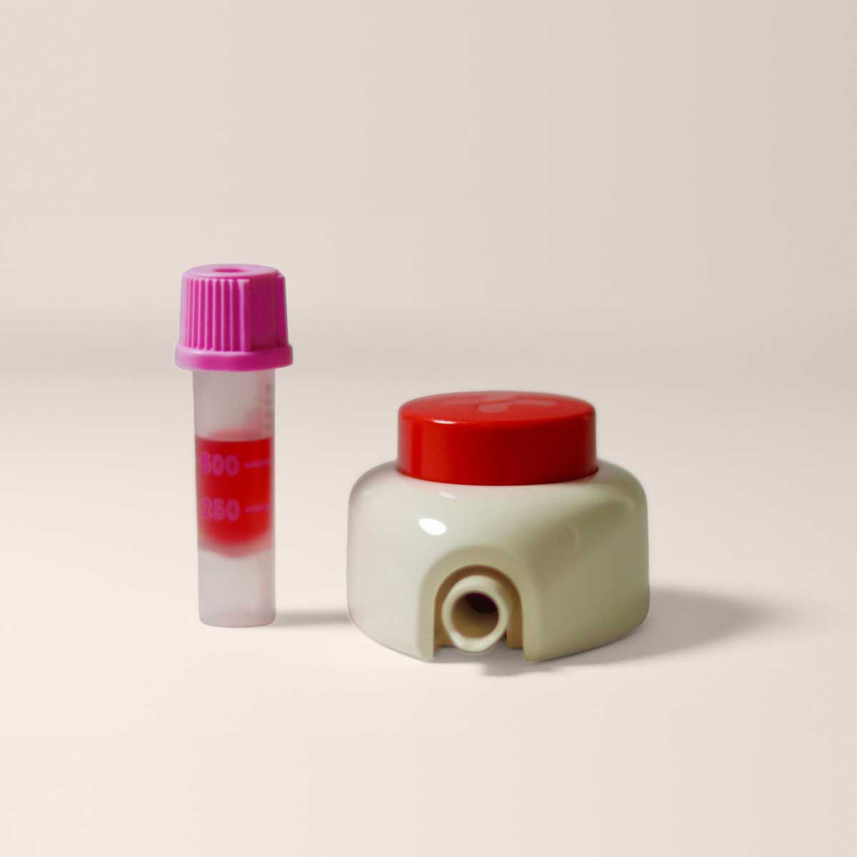 A Tasso device and vial on a cream surface