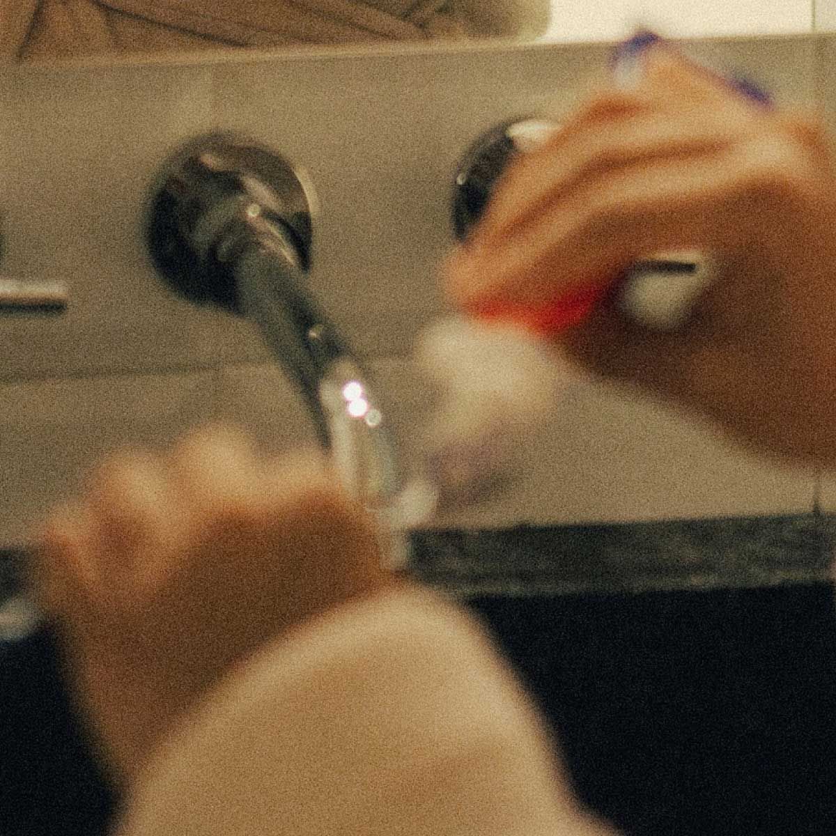 A close up of a woman washing her hands with motion blur