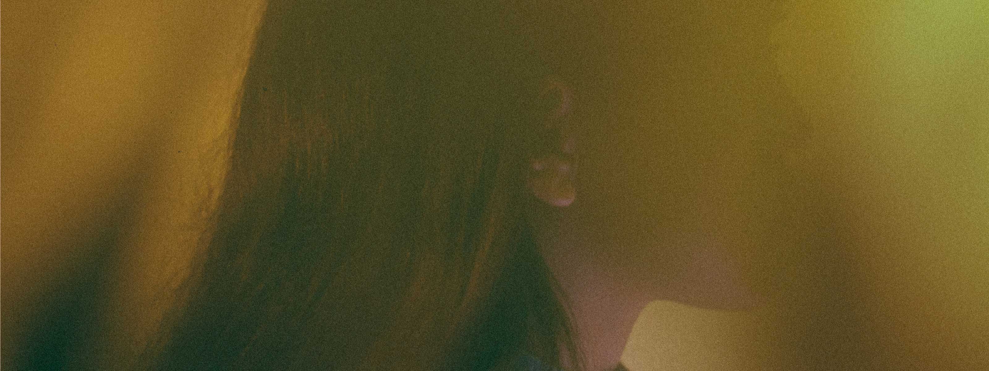 A hazy profile shot of someone at sunset