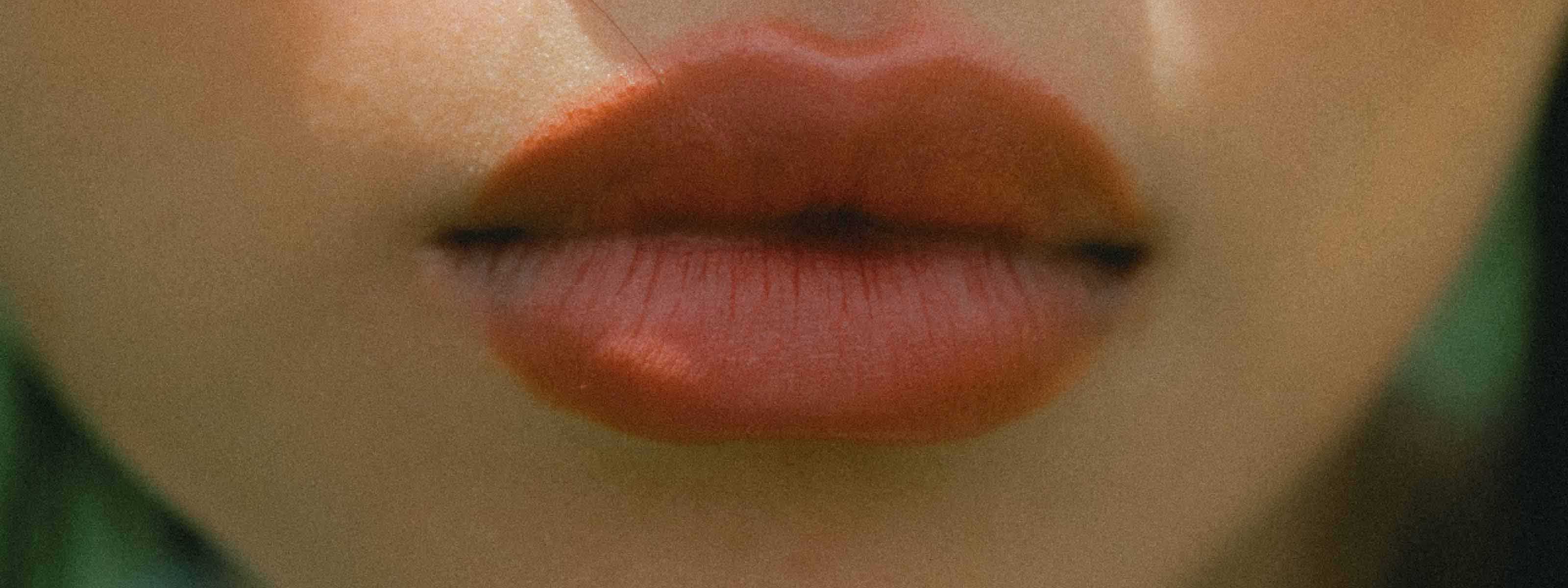 A fuzzy close up of a woman's lips