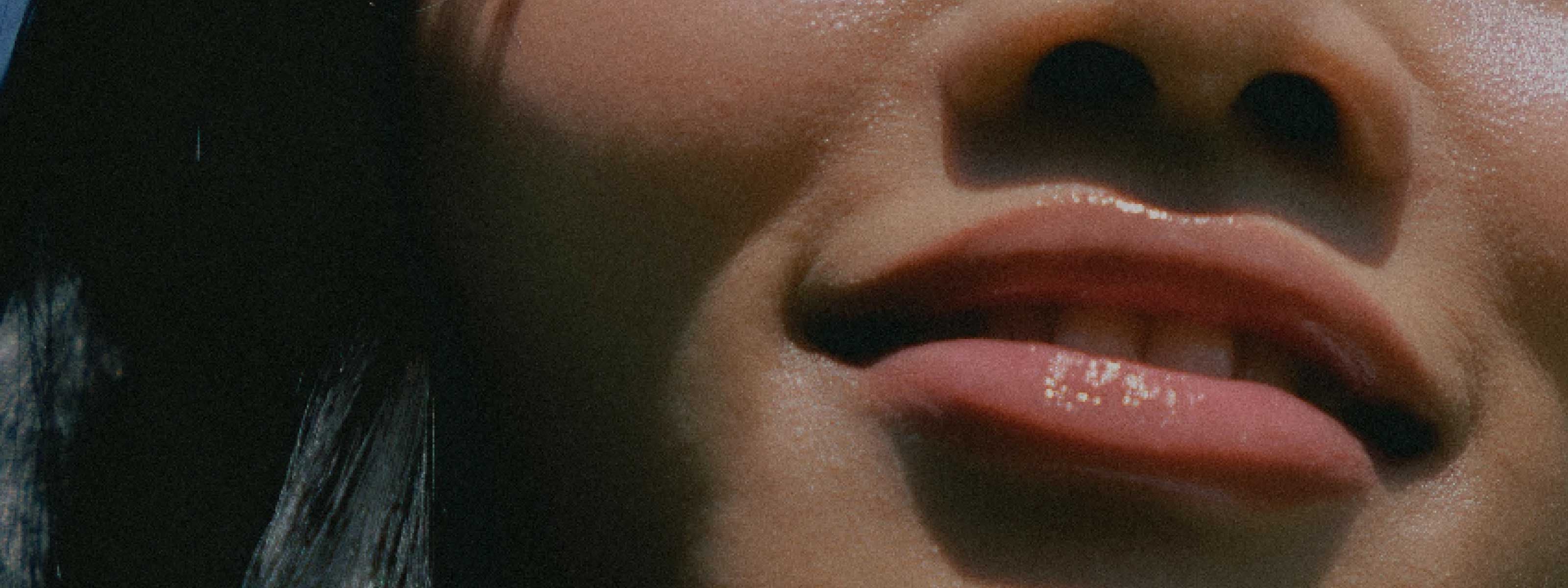 A close up of a woman's moisturized lips