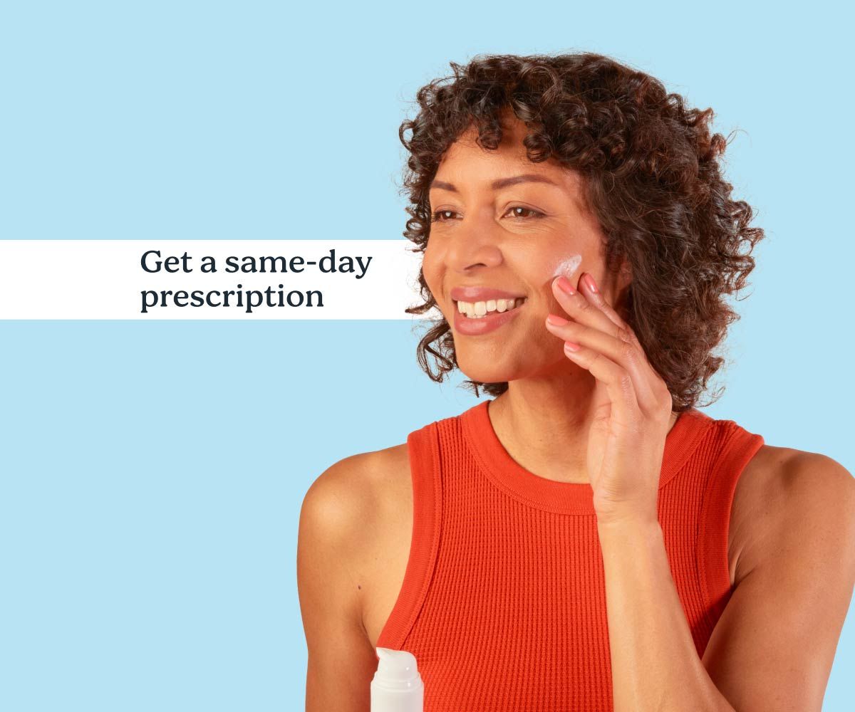 A smiling woman applies topical Spironolactone from Wisp on a blue background