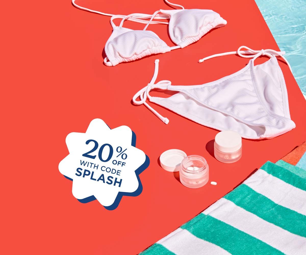 A white bikini, striped towels, and Wisp medications sitting on a red surface next to a pool