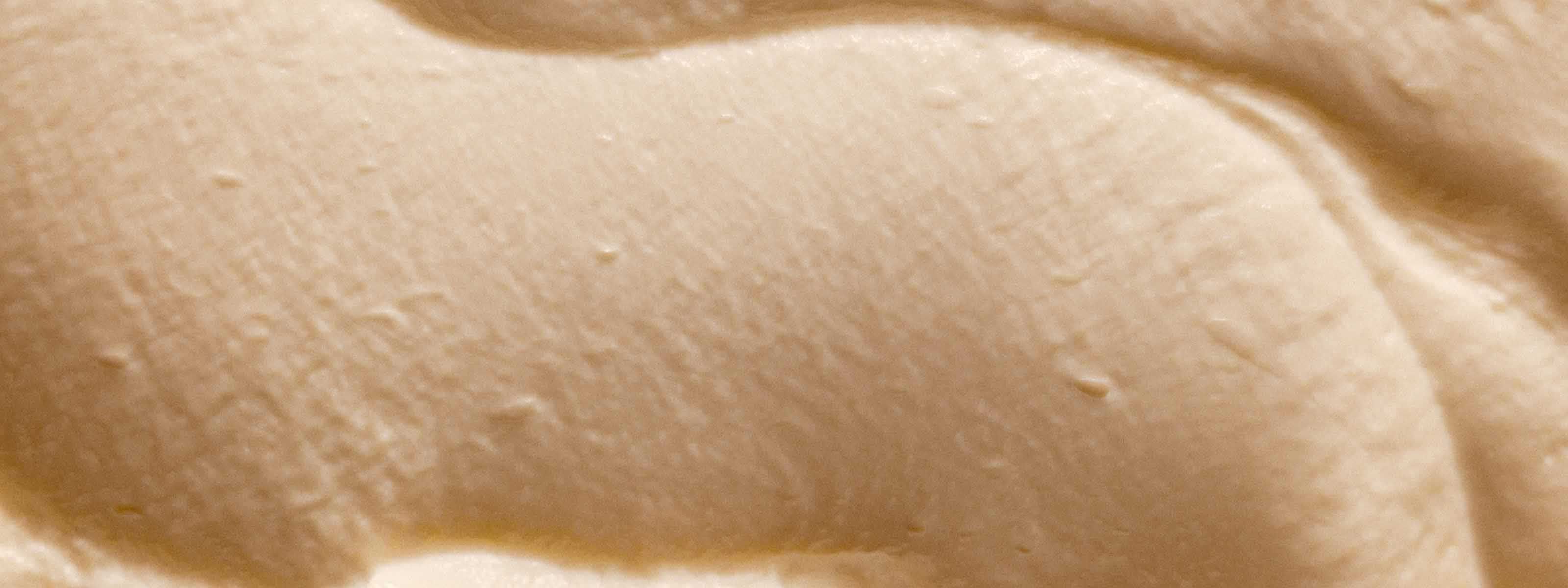 A textural swatch of a beige cream