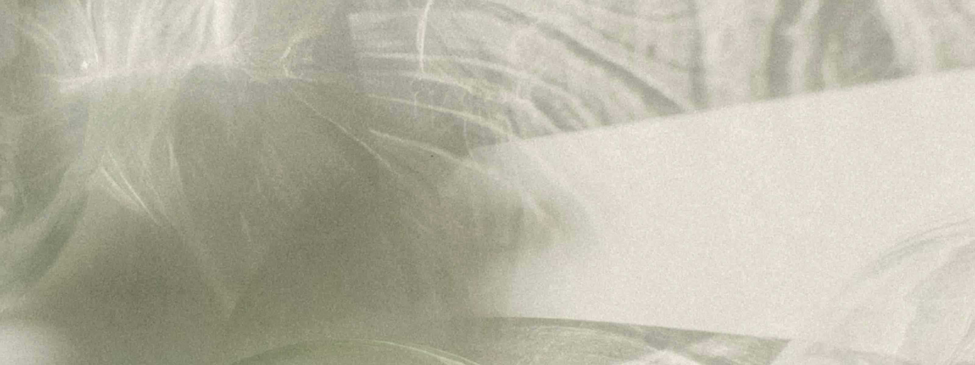 An abstract scene with shadows and light reflected on a cream surface