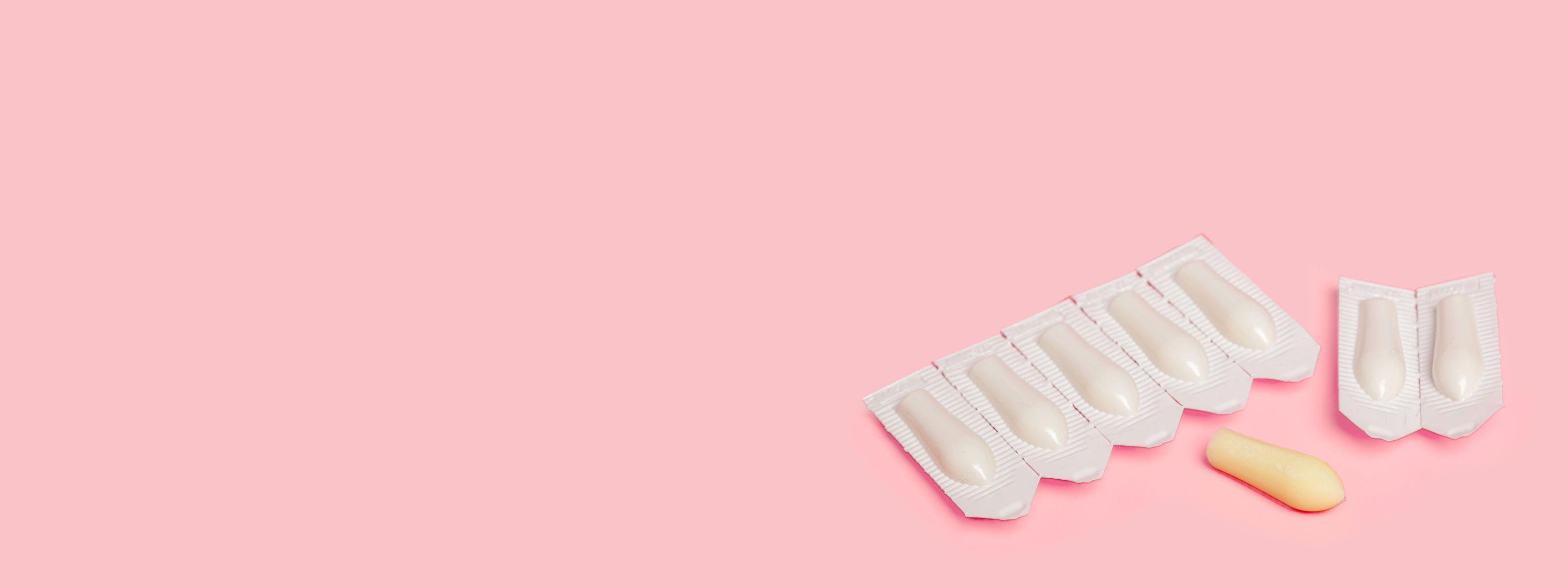 Suppositories to treat hemorrhoids on a pink background