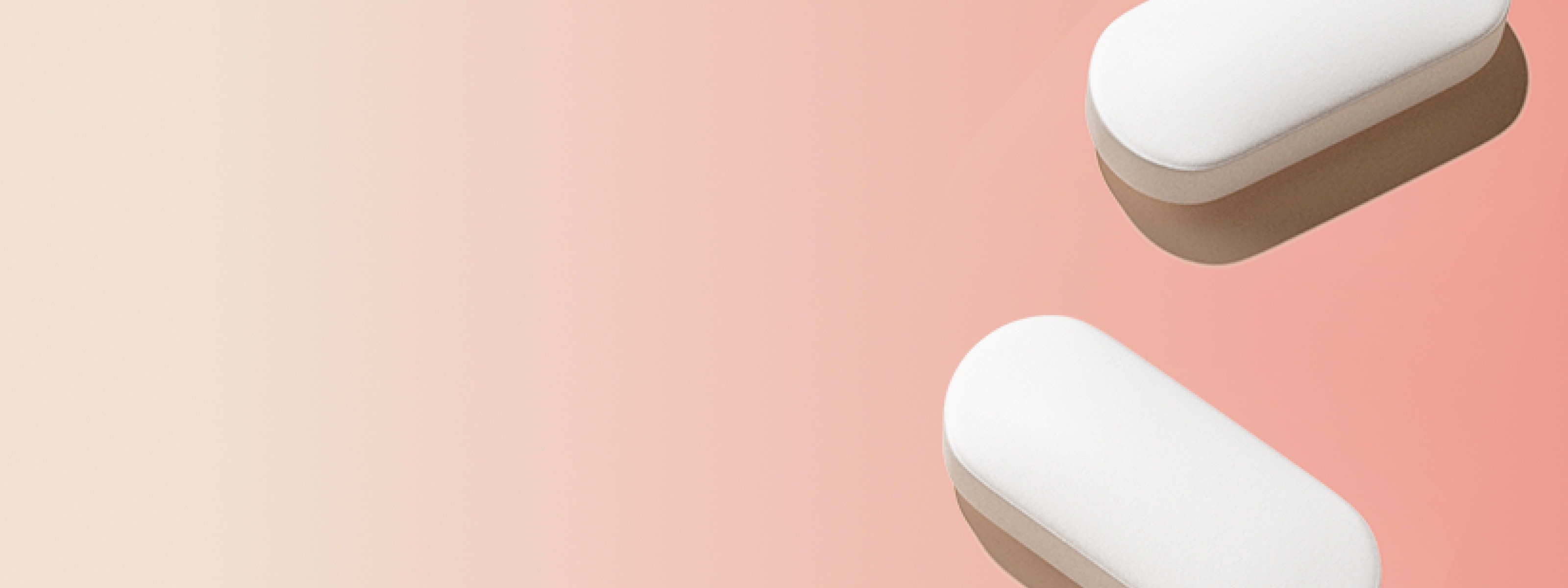 two white pills in front of a light red and beige background