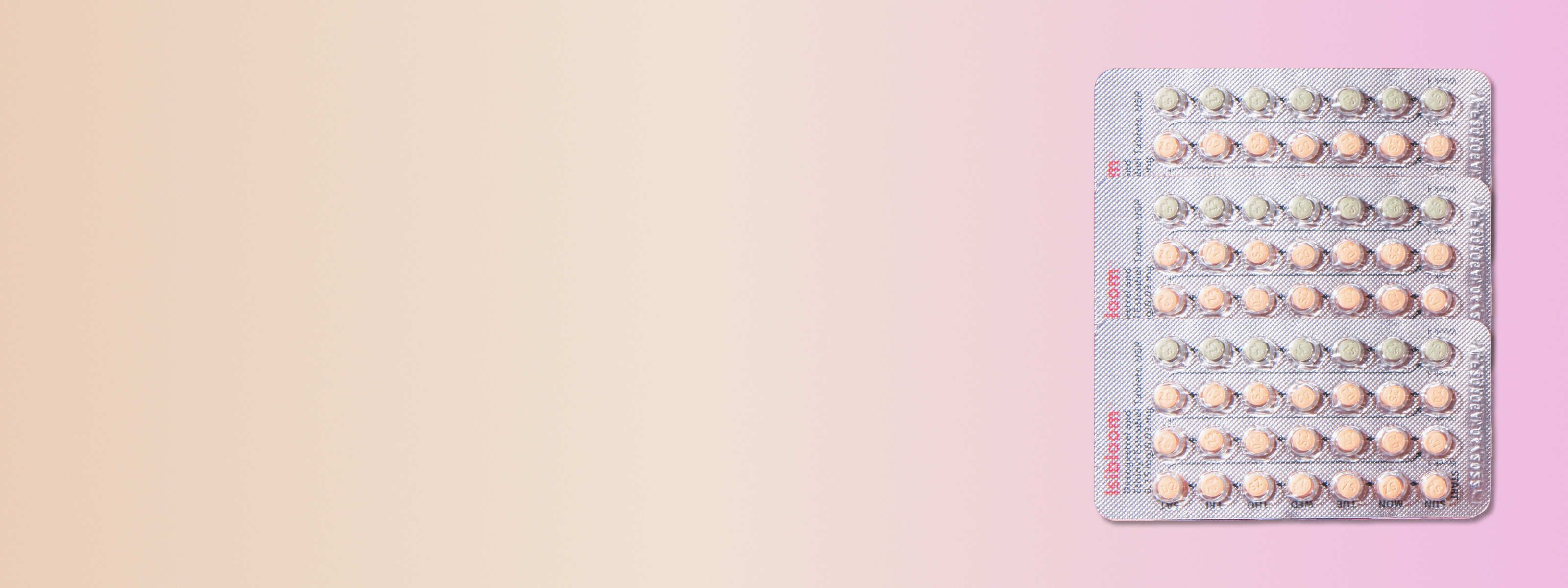 three cyred birth control packs in front of a pink and beige background