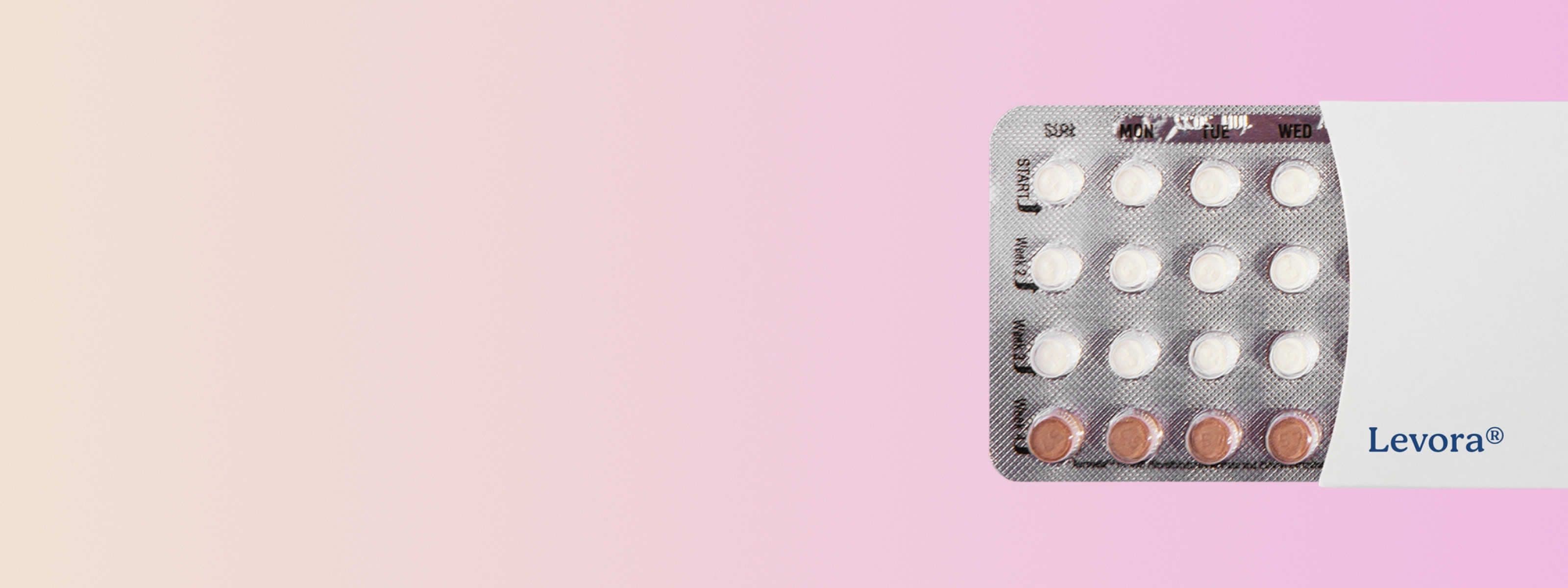 levora birth control pill pack in front of a light pink background