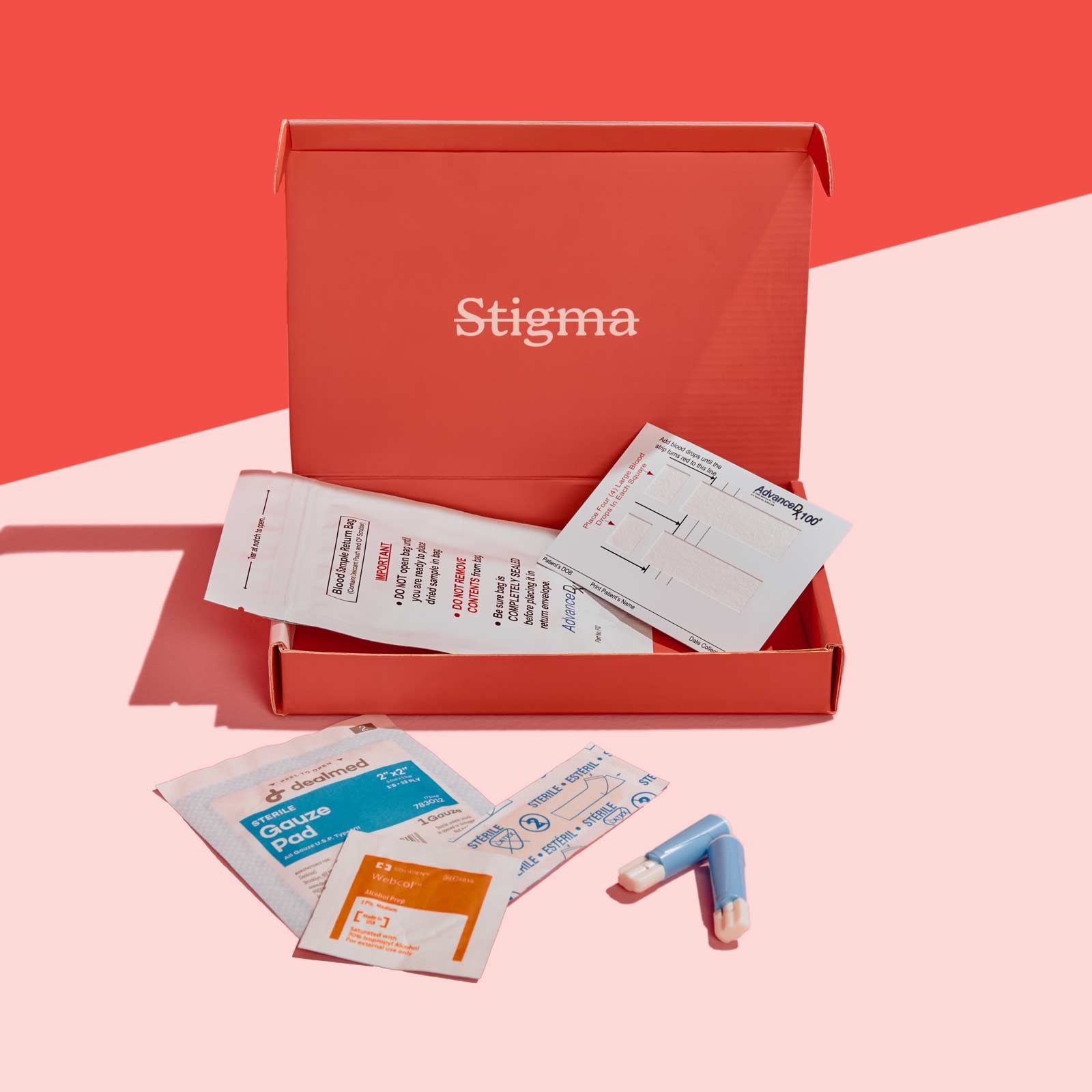 A Wisp diagnostics box with sample collection supplies on a pink surface with a red background