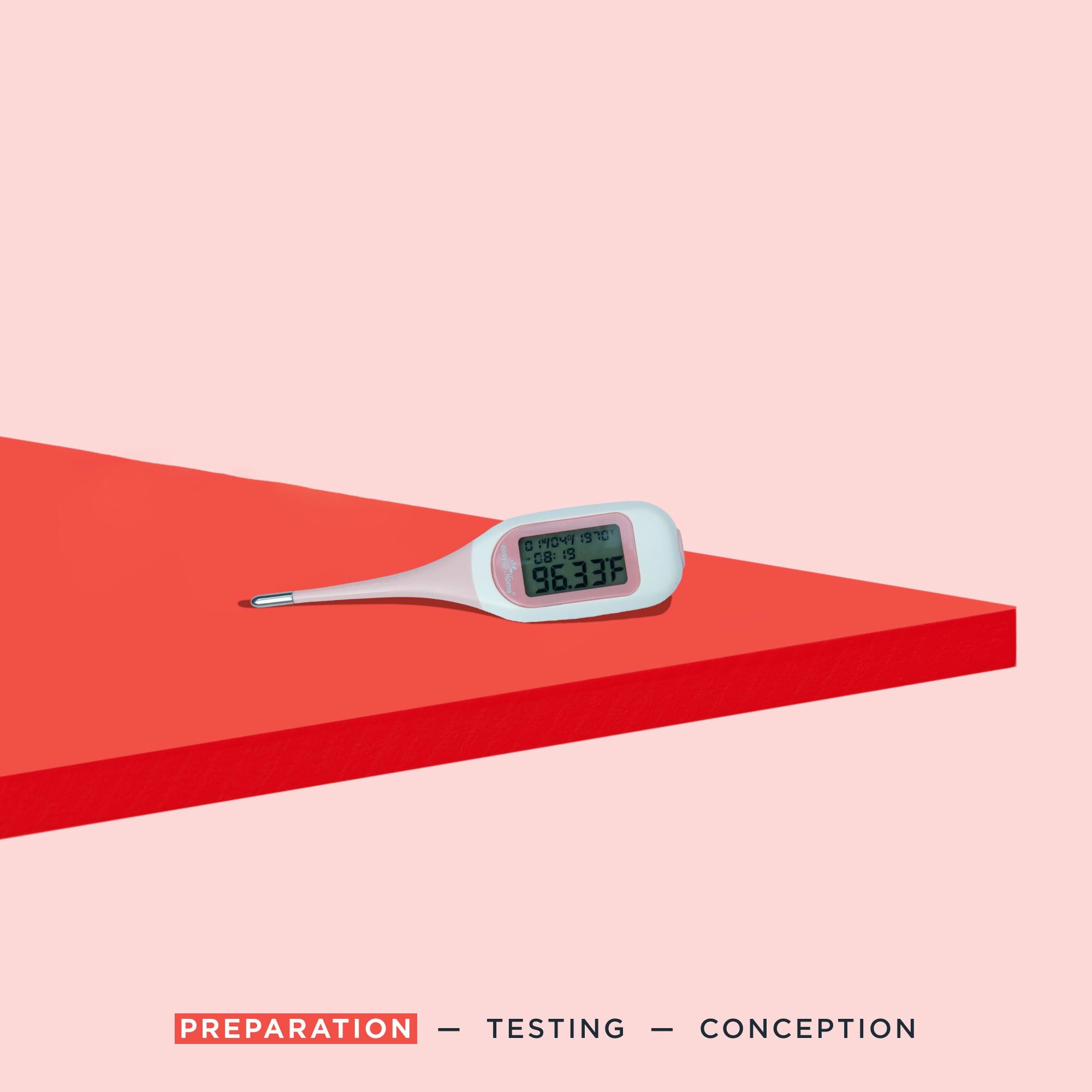 A pink fertility thermometer on a red surface with a pink background