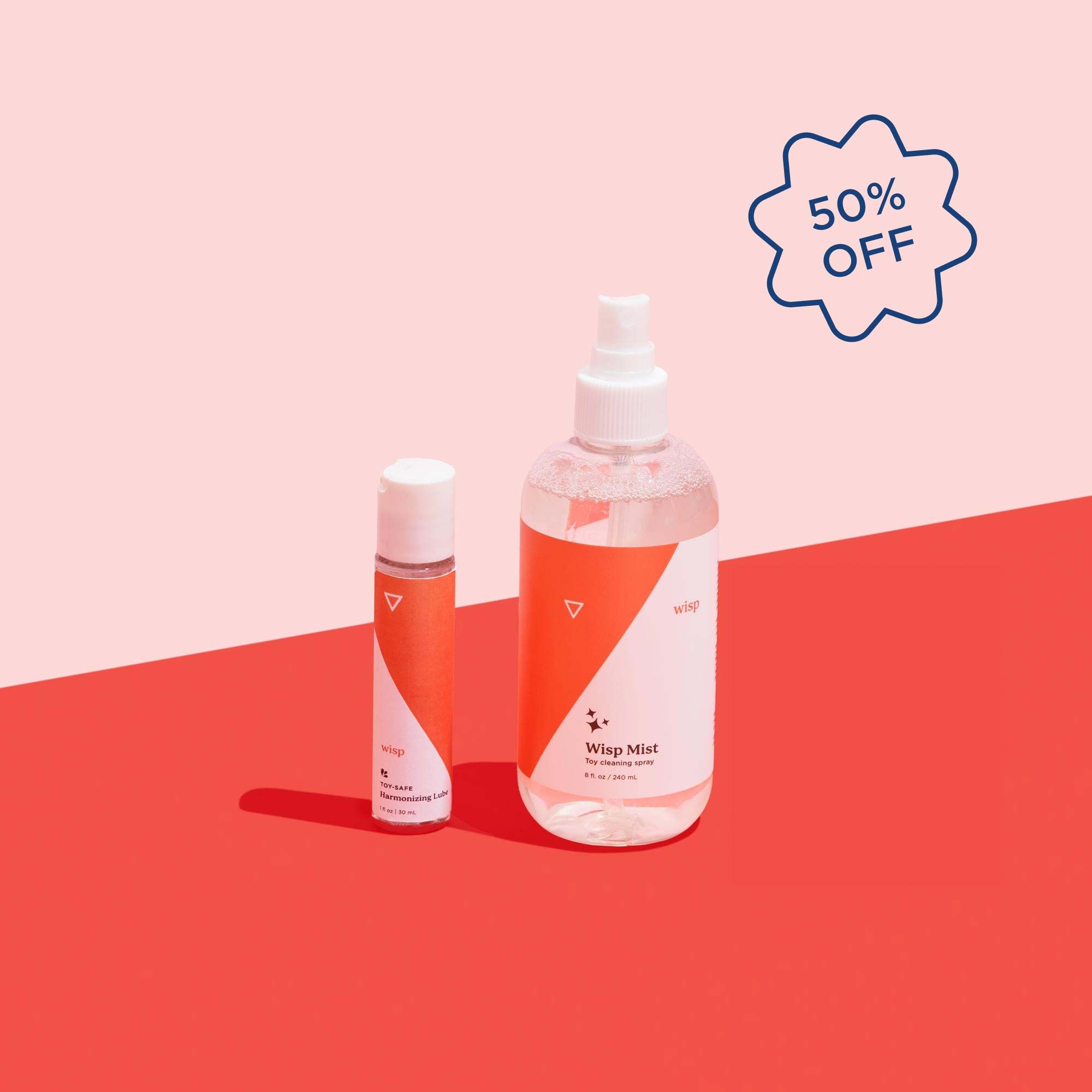bottles of wisp mist spray and toy safe lube with a 50% off call-out on a pink and red geometric background