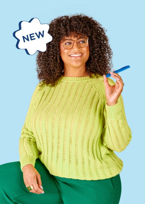 A smiling woman in a green outfit holding an Ozempic injector on a blue background
