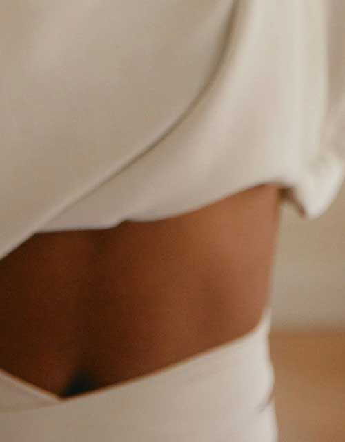 A close up of a woman wearing white lounge clothing
