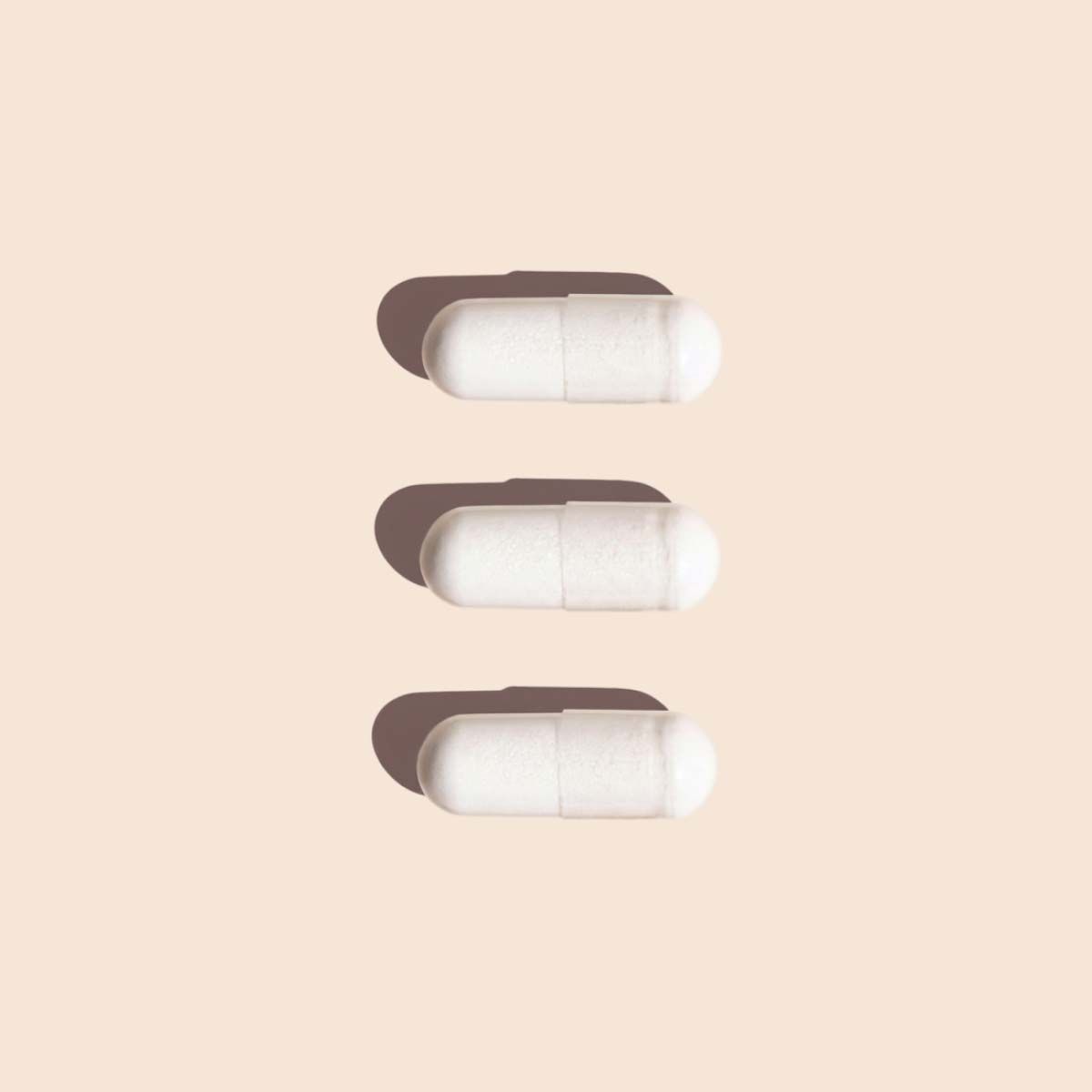 3 Lysine capsules on a cream surface