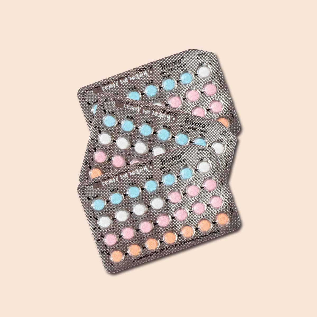3 packets of Low Ogestrel birth control pills on a cream background
