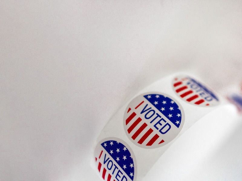 a roll of I Voted stickers on a white surface