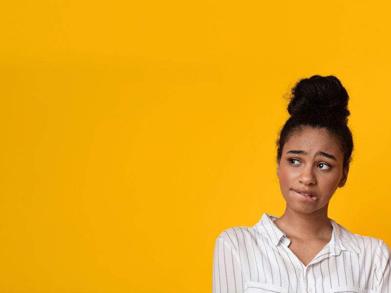 A woman wearing a striped collar shirt has a confused look on her face