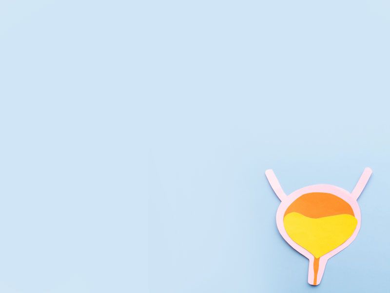 An orange and yellow paper cut out of a bladder on a light blue background