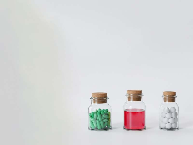 3 bottles of medication on a gray surface