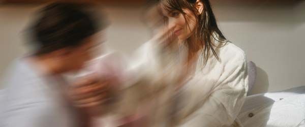 A woman and a man looking at each other intimately with motion blur