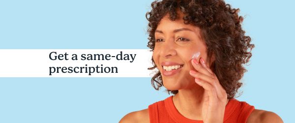 A smiling woman applies topical Spironolactone from Wisp on a blue background