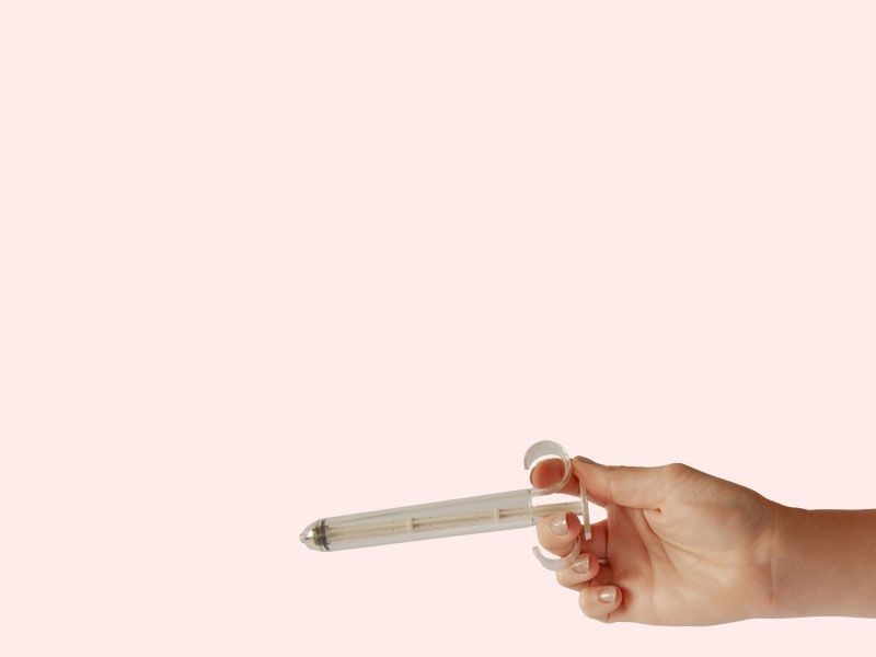 A woman's hand holding PherDal's FDA approved sterile at-home insemination syringe