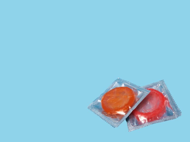 2 colorful condoms on a light blue background