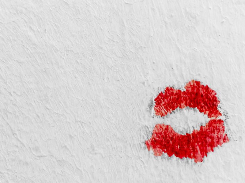 Red lipstick kiss on a white wall