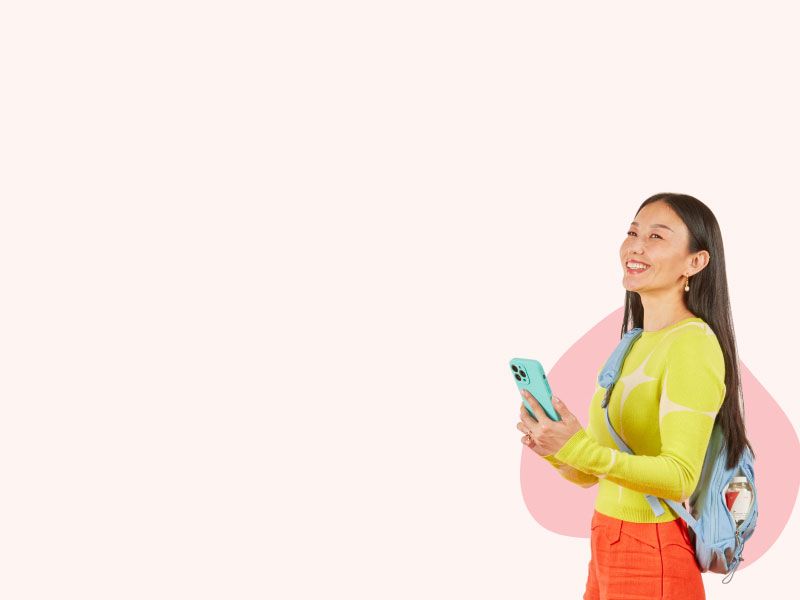 Women holding a phone and carrying a backpack with Wisp medication in it on a pink background