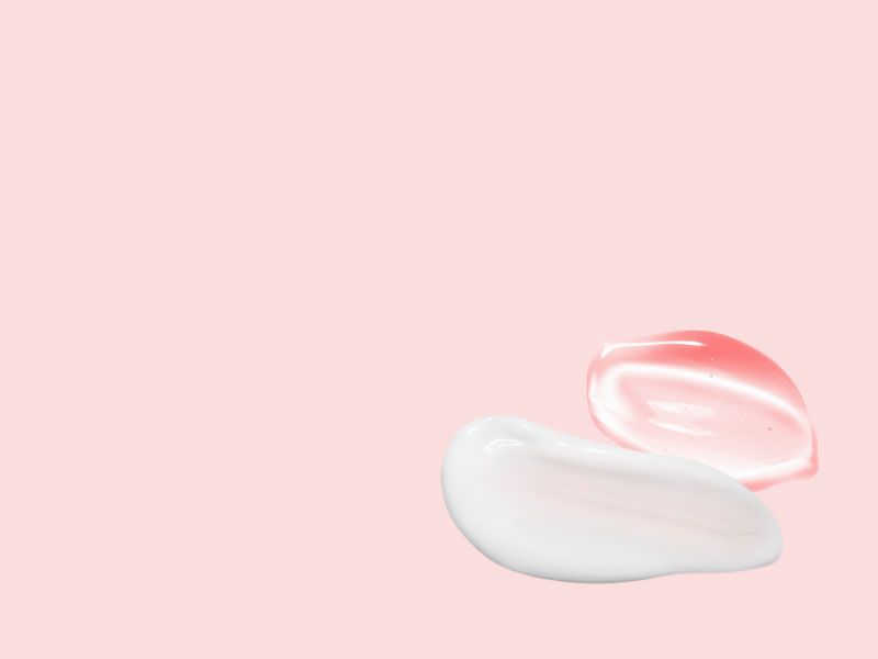 A white cream swatch and a clear gel swatch on a pink surface