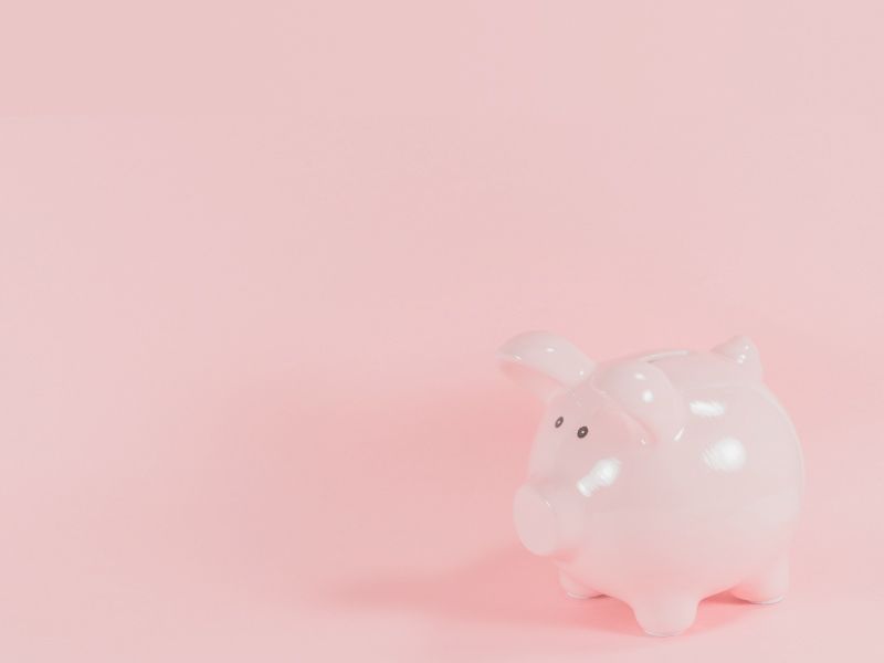 A pink piggy bank with a pink background