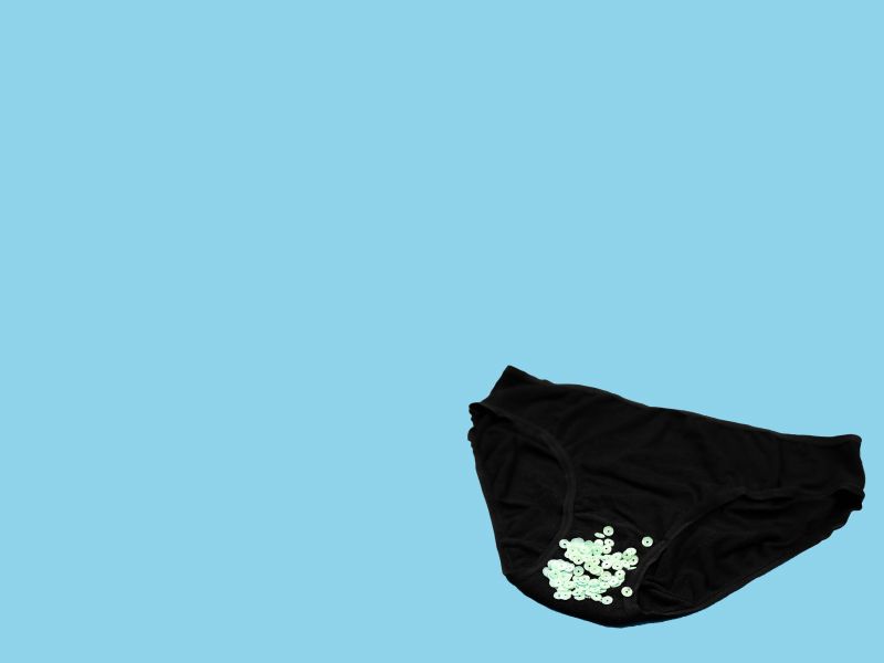 Black underwear with glitter sprinkled on them with a light blue background