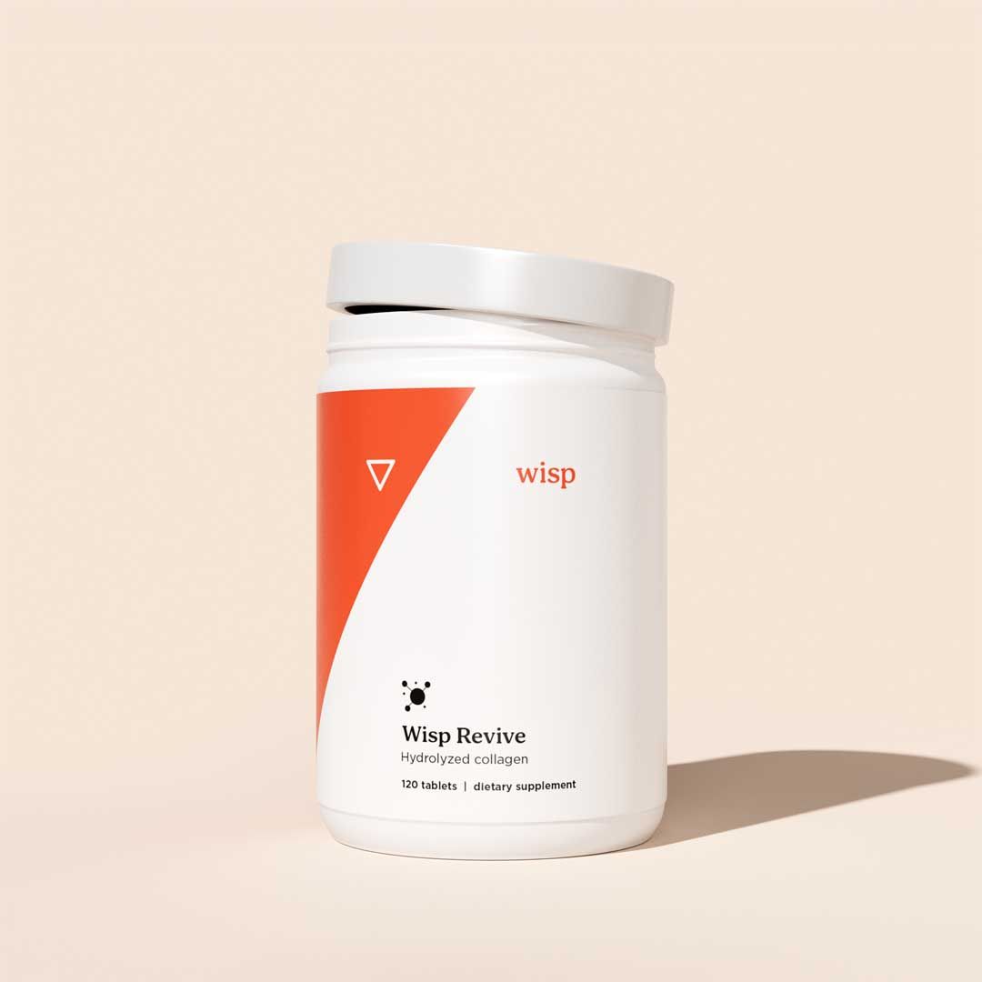A bottle of Wisp Revive Collagen on a cream surface