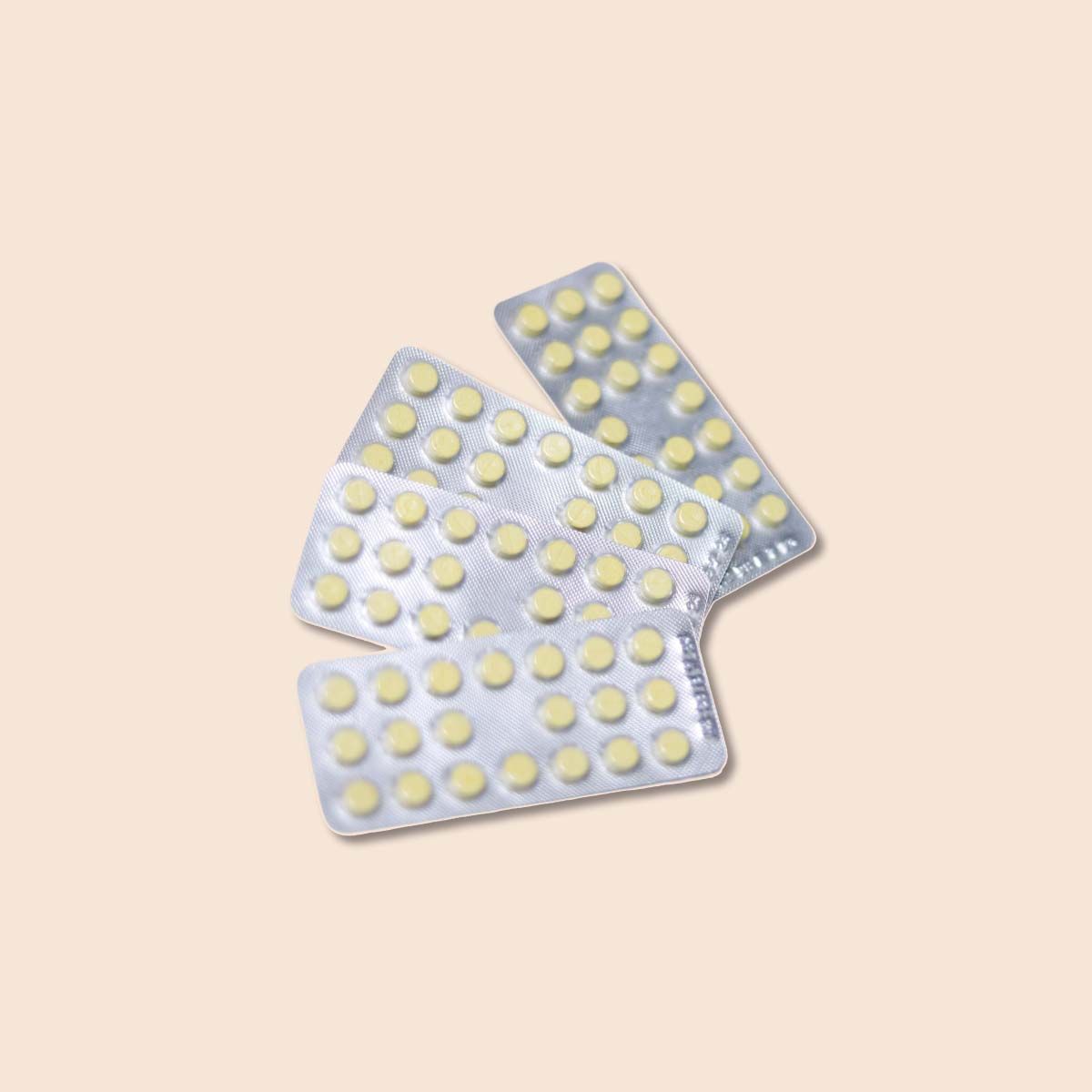Packet of Sprintec birth control pills on a cream background