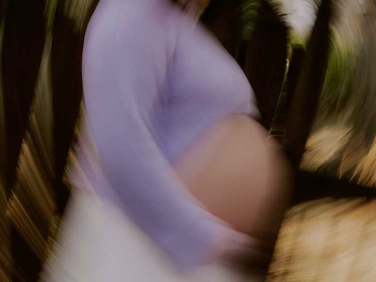 close up, in motion profile of pregnant belly