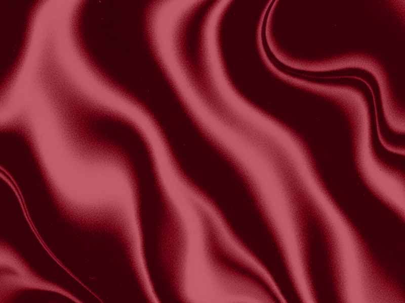 Flowing deep red satin fabric with soft folds and a silky sheen