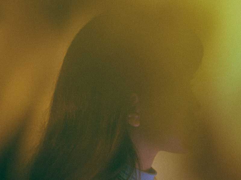 A hazy profile shot of someone at sunset