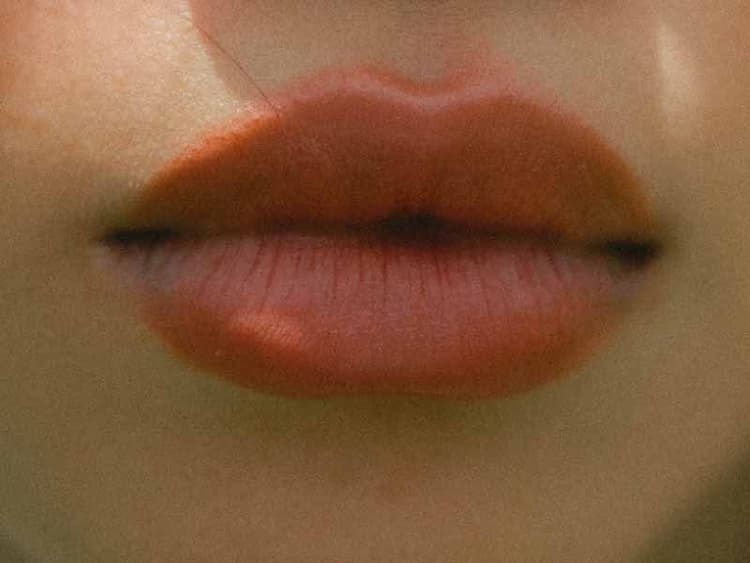 A fuzzy close up of a woman's lips