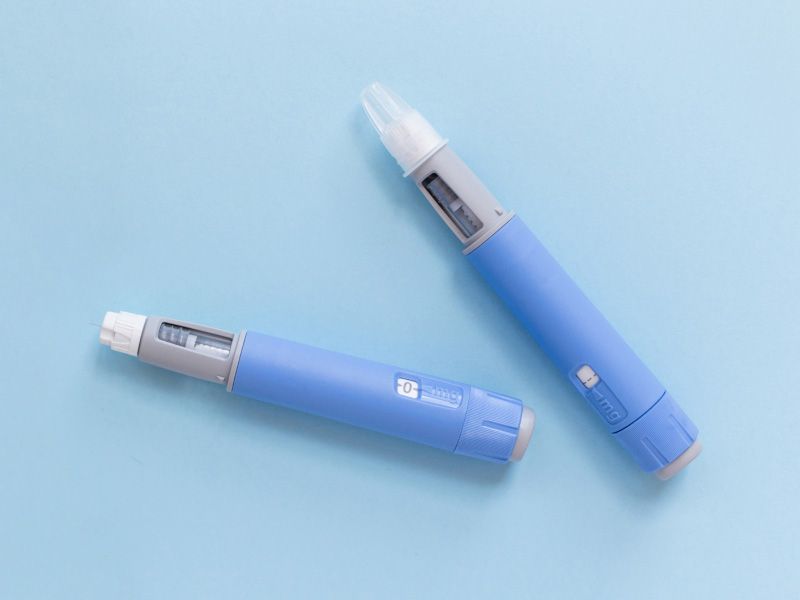 Two Semaglutide pens on a light blue background