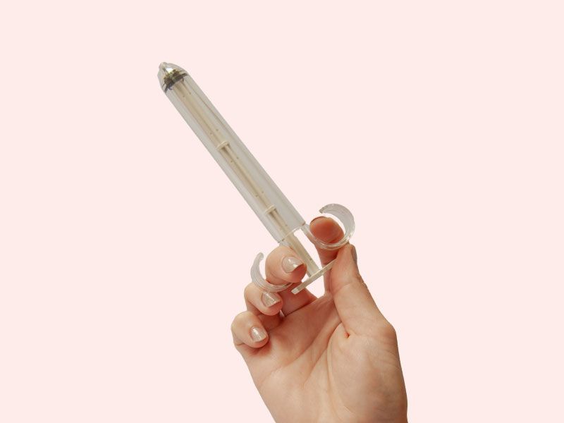 A woman's hand holding PherDal's FDA approved sterile at-home insemination syringe