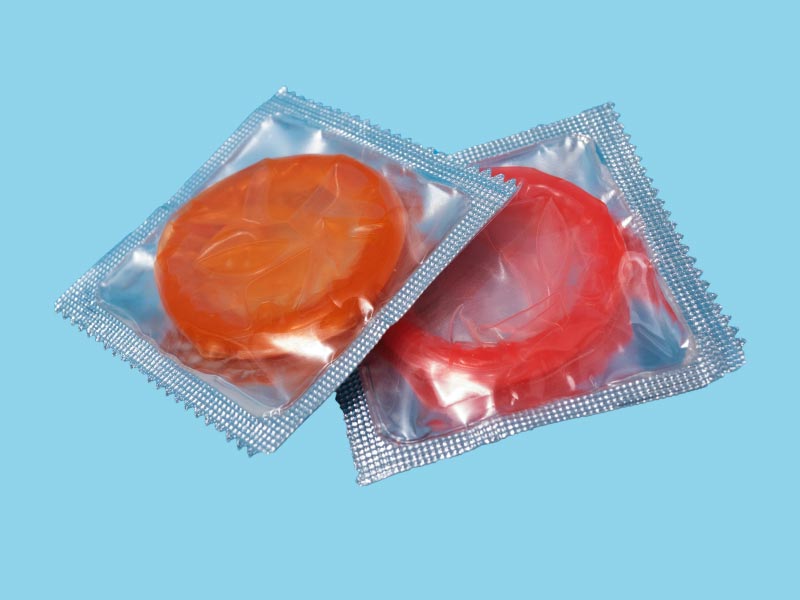 2 colorful condoms on a light blue background