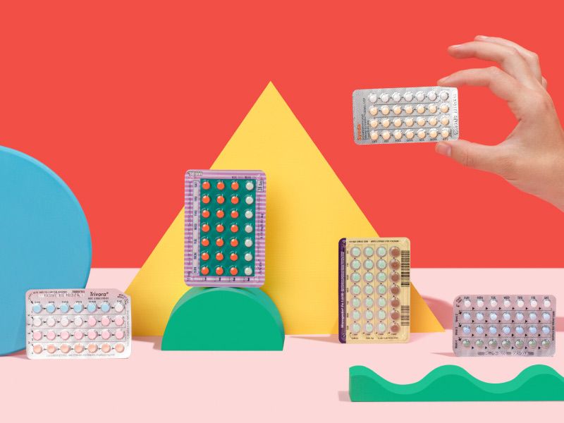 a woman picks up one of many birth control packets on a colorful geometric background