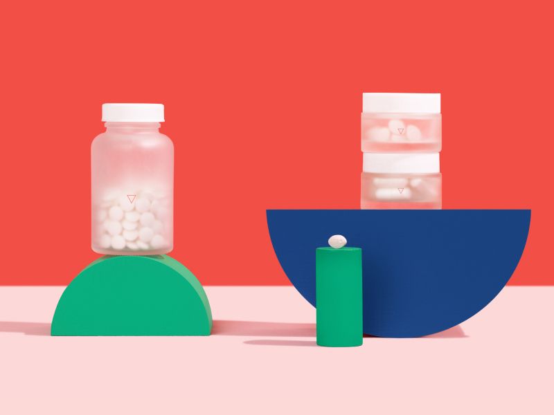 Wisp yeast infection meds in glass jars on a colorful geometric background