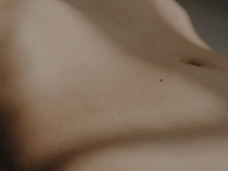 An image of a person's abdomen with moody lighting