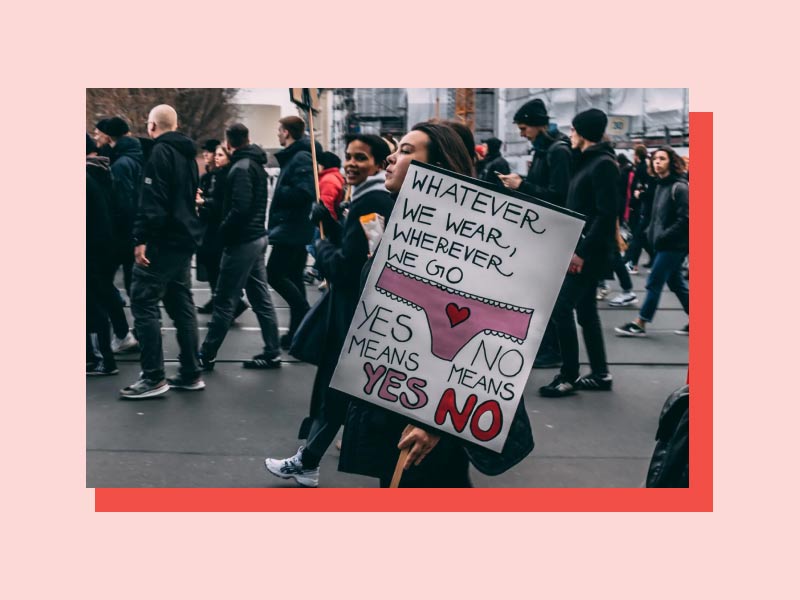 Protesters and a sign supporting women's rights and sex positivity